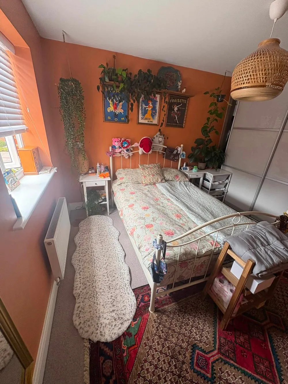 Same bedroom after cleaning, bed made and floor clear