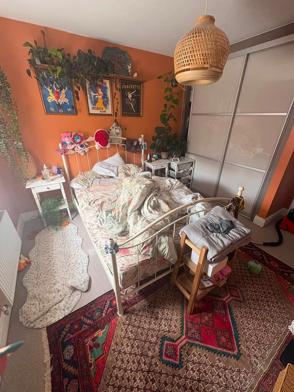 Bedroom before cleaning, with an unmade bed and clutter on the floor