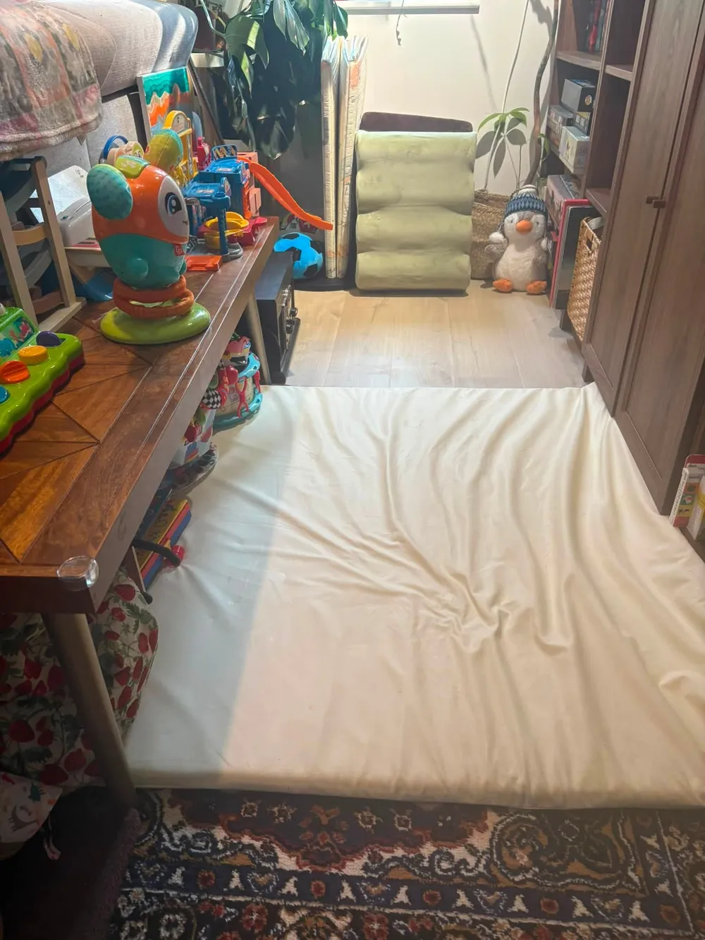 Same playroom after cleaning, toys tidied away and floor clear