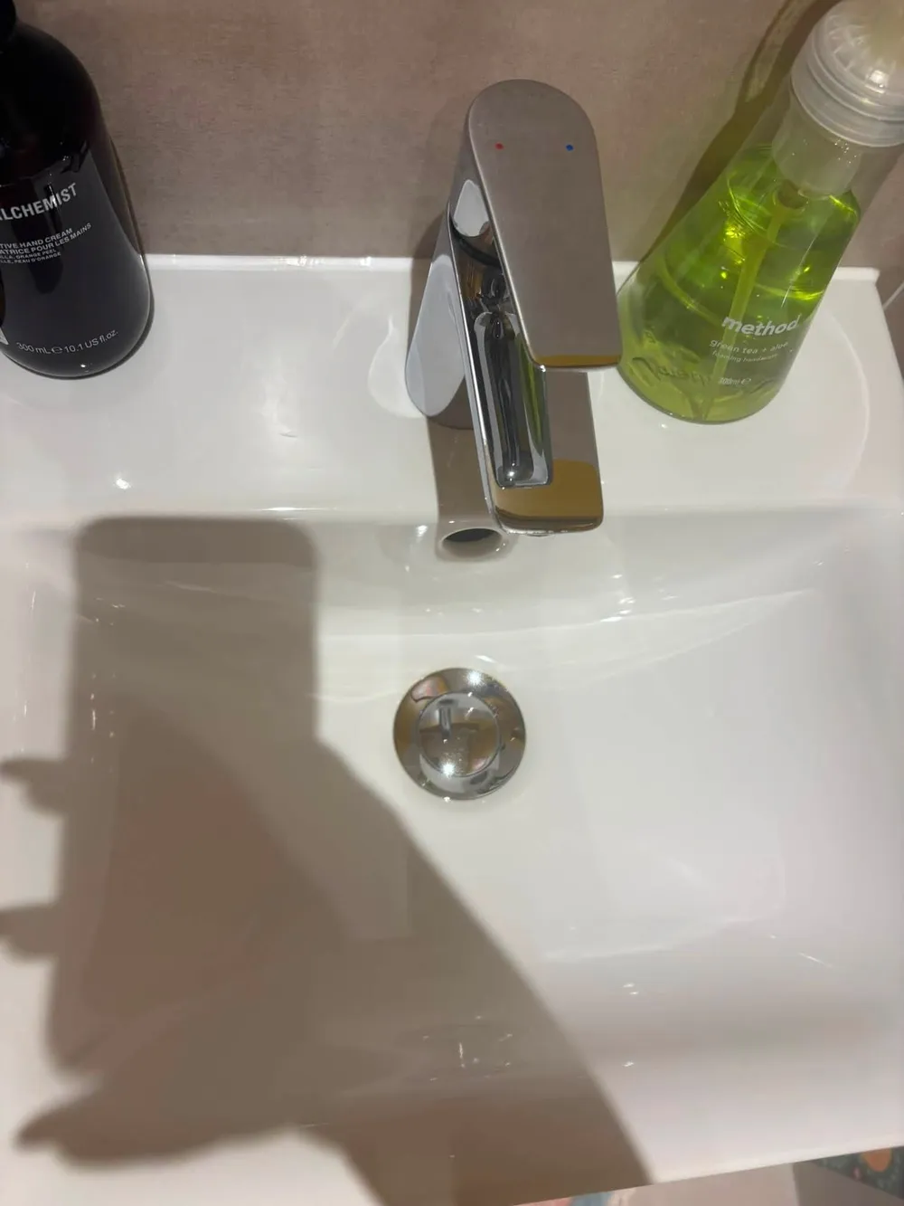Same bathroom tap after cleaning, chrome clear and shining
