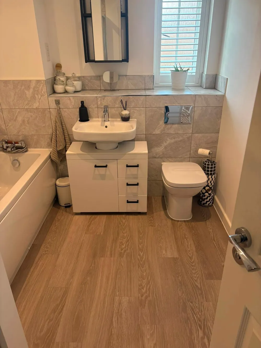Bathroom cleaned, with polished basin, mirror and floor